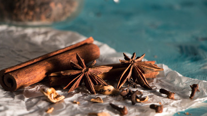 Fototapeta na wymiar Brown spices, anise and cinnamon at white and blue background, christmasy mood