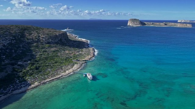 Aerial shot of a bright sunny day on a Mediterrenian coast of Crete island, Greece. 4K, UHD