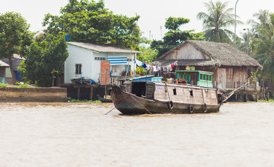 Cai Be, Vietnam-December 10, 2013. Traditional vietnamese house boat stands on the Mekong River on...