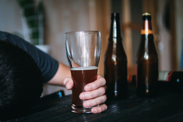 The problem of alcoholism. A young man uses a lot of beer