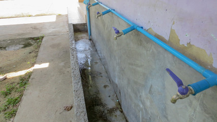 row of faucet and pipe in school at Thailand