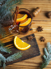 Autumn and winter seasonal mulled wine on a wooden table with spices