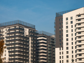 Fototapeta na wymiar Modern apartment buildings on a sunny day with a blue sky. Facade of a modern apartment building.