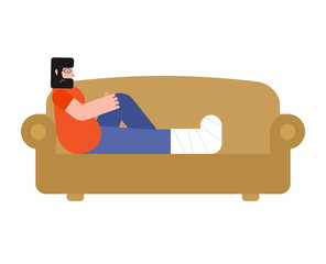 Man on sofa with broken leg isolated.