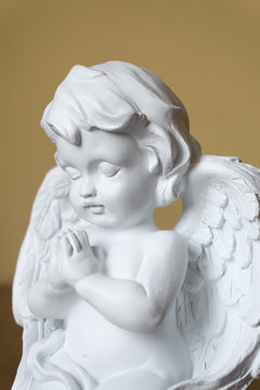 Statue of angel with folded hands praying