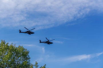 Greek Air Force Apache helicopters flying. 
2 Boeing AH-64 attack helicopters flying at 28 October military parade, commemorating the Greek no against Italian 1940 ultimatum.