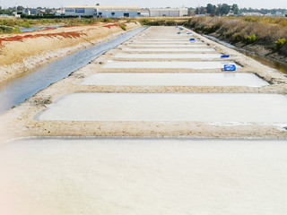 Fototapeta premium Traditional saltworks. Isla Cristina, Huelva, Spain. Deposits sediments, canals and mud flats. Southern Andalusia saltworks.