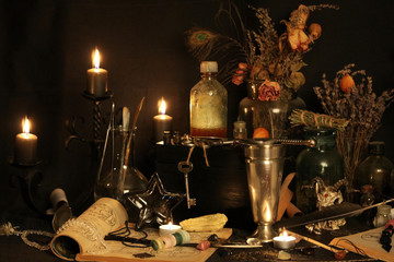 Antique Magic Book. Witchcraft Peacock feathers and candle background. Black candle Magic Ritual.