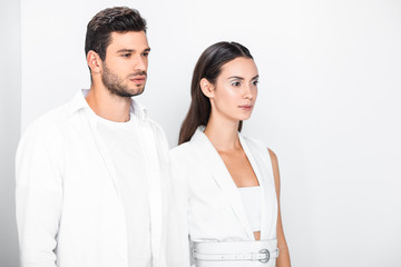 adult stylish couple in total white posing together