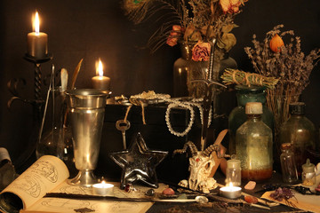 Antique Magic Book. Witchcraft Peacock feathers and candle background. Black candle Magic Ritual.
