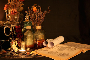 Antique Magic Book. Witchcraft Peacock feathers and candle background. Black candle Magic Ritual.