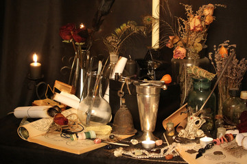 Antique Magic Book. Witchcraft Peacock feathers and candle background. Black candle Magic Ritual.