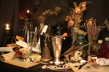Antique Magic Book. Witchcraft Peacock feathers and candle background. Black candle Magic Ritual.