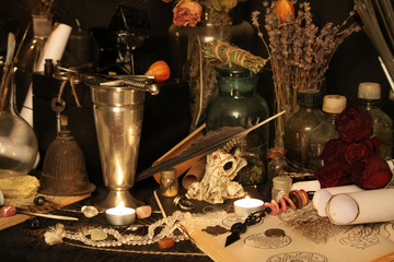 Antique Magic Book. Witchcraft Peacock feathers and candle background. Black candle Magic Ritual.