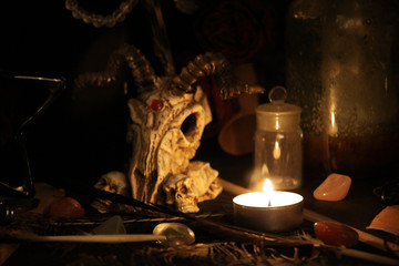 Antique Magic Book. Witchcraft Peacock feathers and candle background. Black candle Magic Ritual.