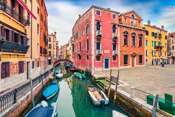 Fototapeta na wymiar Picturesque spring view of Vennice with famous water canal and colorful houses. Splendid morning scene in Italy, Europe. Magnificent Mediterranean cityscape. Traveling concept background.