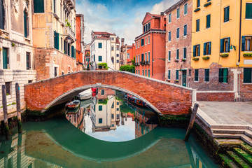 Fototapeta na wymiar Bright spring view of Vennice with famous water canal and colorful houses. Splendid morning scene in Italy, Europe. Magnificent Mediterranean cityscape. Traveling concept background.