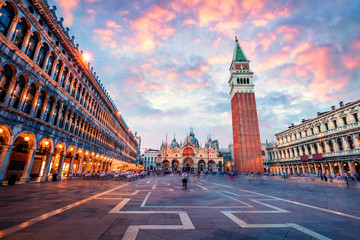 Fototapeta na wymiar Fantastic sanset on San Marco square with Campanile and Saint Mark's Basilica. Colorful evening cityscape of Venice, Italy, Europe. Traveling concept background. Artistic style post processed photo.