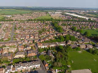 Typical UK Town aerial photo showing rows of houses, roads, parks and communal area