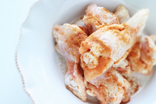 Cumin powder and chicken drumsticks for cooking image