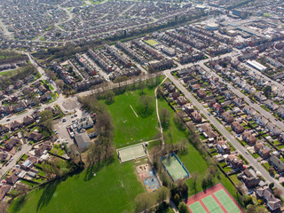 Typical UK Town aerial photo showing rows of houses, roads, parks and communal area