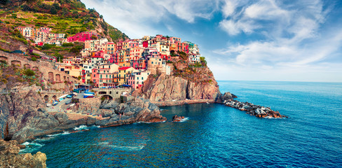 Second city of the Cique Terre sequence of hill cities - Manarola. Colorful spring morning in...