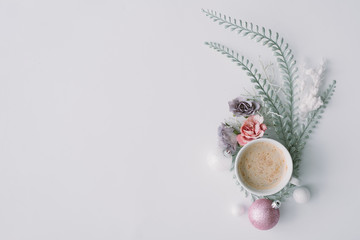 Creative winter natural composition with flowers, coffe cup and Christmas decoration. Flat lay, table top view.