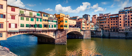 Picturesque medieval arched river bridge with Roman origins - Ponte Vecchio. Colorful spring morning view of the Arno river in Florence, Italy, Europe. Traveling concept background.