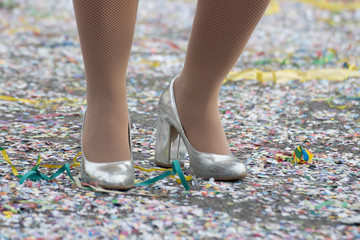 Closeup of silver shoes and confetti at Carnival