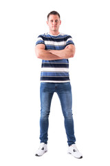 Serious successful man with blank facial expression looking at camera with crossed arms. Full body isolated on white background. 