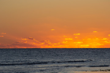 Fototapeta na wymiar Sunset at the beach with orange colors