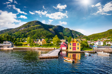 Picturesque summer view of typical Norwegian village on the shore of fjord. Traveling concept...