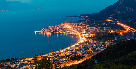 Fototapeta premium View from the bird's-eye of Kamena Vourla town in the evening light. Colorful spring cityscape in Greece, Europe. Beautiful sunset on Aegean Sea. Traveling concept background.