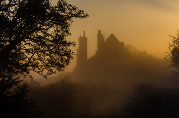 Silhouette of house in mist