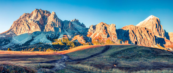 Panorama from top of Falzarego pass with Lagazuoi mountain. Colorful autumn morning in Dolomite...