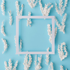 Composition of snowy Christmas tree branches on pastel blue background. Flat lay.