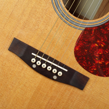 Musical instrument - Top view pickguard, bridge, pins and strings acoustic guitar
