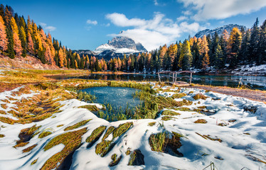 Great sunny scene on Antorno lake with Tre Cime di Lavaredo (Drei Zinnen) mount. Colorful autumn landscape in Dolomite Alps, Province of Belluno, Italy, Europe. Beauty of nature concept background.