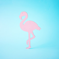 Pink flamingo shape on bright blue background. Summer tropical composition with copy space. Flat lay minimal. Summer Holiday layout.