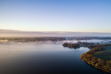 Fototapeta na wymiar Morning mist on the banks of big lake