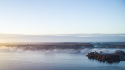 Morning mist on the banks of big lake