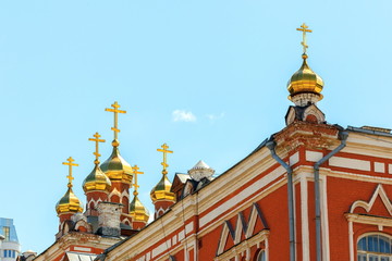 Golden domes and crosses of the Iberian monastery against the blue sky