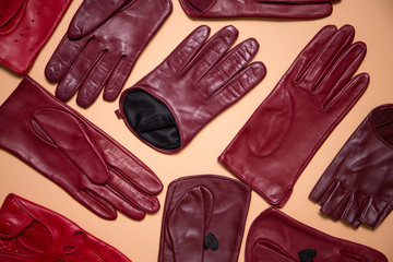Fototapeta na wymiar background of a variety of gloves on beige