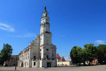 Fototapeta na wymiar Town Hall White Swan in the center of Kaunas at the Town Hall Square in Lithuania in the spring against a blue sky.