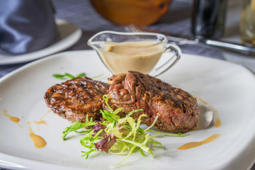 two fried pieces of meat with sauce