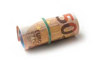closeup of banknotes roll of fifty euros money on white background