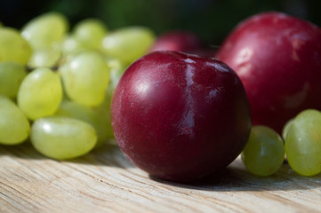 delicious grapes and fruits on a wooden table