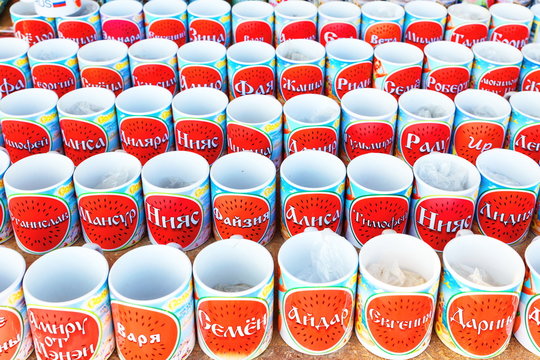 Russia, salt-Iletsk, August 2017: glasses with a name standing in a row in the market. Text in Russian: Varya Semyon Aydar Eugenia Darina Lydia Timothy Ira Zhanna Stanislav and other names.