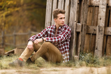 Handsome young guy in nature on an autumn day