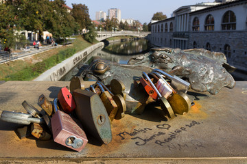 bronze frog is holding Love locks on Buther's bridge in Ljubljana